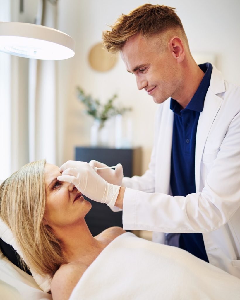 doctor-injecting-botox-into-the-forehead-of-a-mature-woman